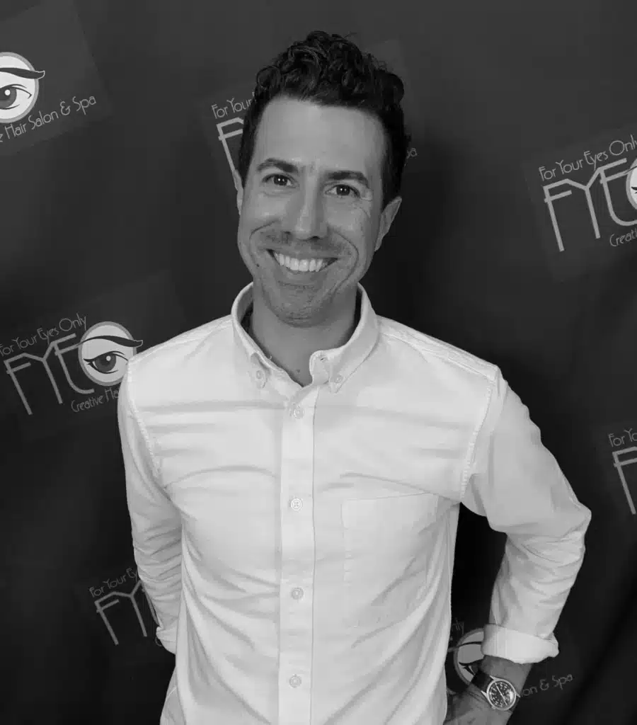Richard McGraw wearing a white shirt, professional hairstylist specializing in haircuts, custom color, and curly hair in Jacksonville, Florida.